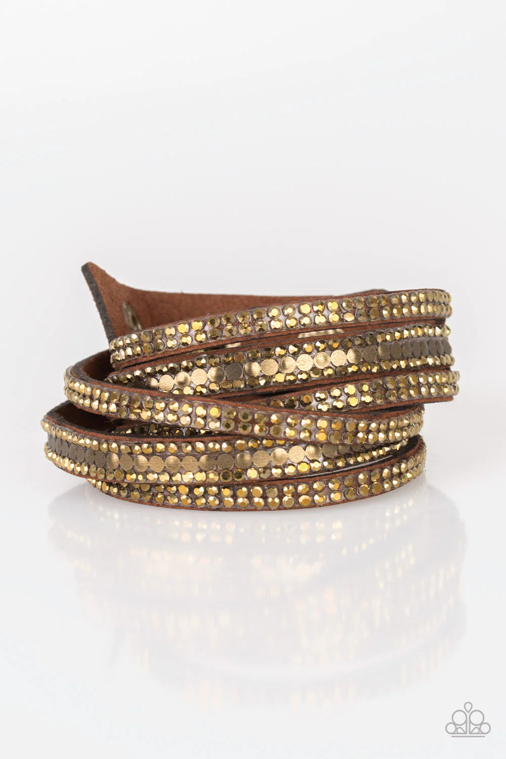Encrusted in rows of glittery aurum rhinestones and flat brassl studs, three strands of brown suede wrap around the wrist for a sassy look. The elongated band allows for a trendy double wrap around the wrist. Features an adjustable snap closure.  Sold as one individual bracelet.