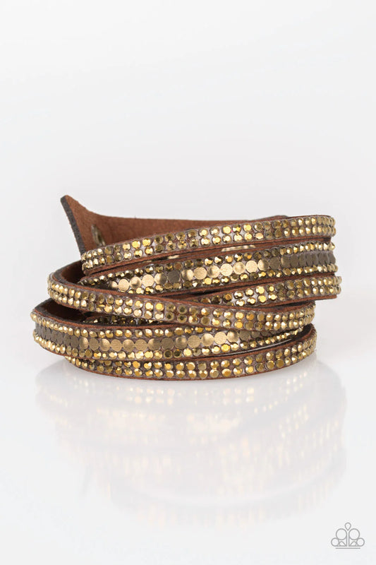 Encrusted in rows of glittery aurum rhinestones and flat brassl studs, three strands of brown suede wrap around the wrist for a sassy look. The elongated band allows for a trendy double wrap around the wrist. Features an adjustable snap closure.  Sold as one individual bracelet.