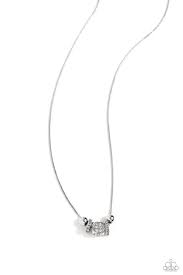 Embossed in glistening white rhinestones, a three-dimensional silver dice pendant glides beside silver accents, and rounded square frames, also dotted in white rhinestones, along an extended silver snake chain for a Vegas-inspired centerpiece. Features an adjustable clasp closure.  Sold as one individual necklace. Includes one pair of matching earrings.