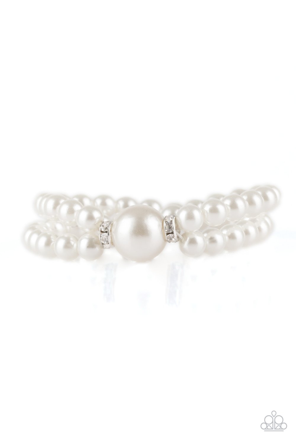 Joined at the center by an oversized white pearl and a pair of white rhinestone encrusted rings, classic white pearls are threaded along stretchy bands around the wrist for a timelessly layered look.
Sold as one individual bracelet.