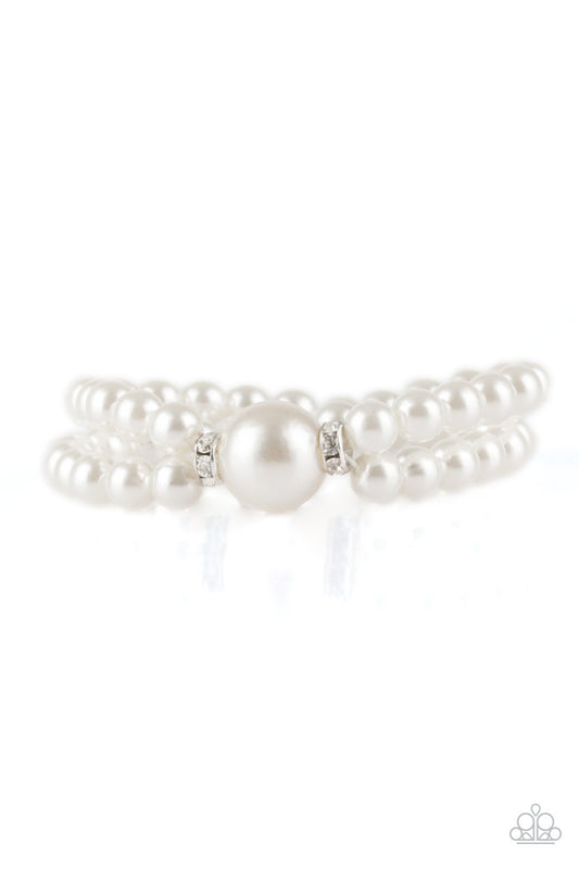 Joined at the center by an oversized white pearl and a pair of white rhinestone encrusted rings, classic white pearls are threaded along stretchy bands around the wrist for a timelessly layered look.
Sold as one individual bracelet.