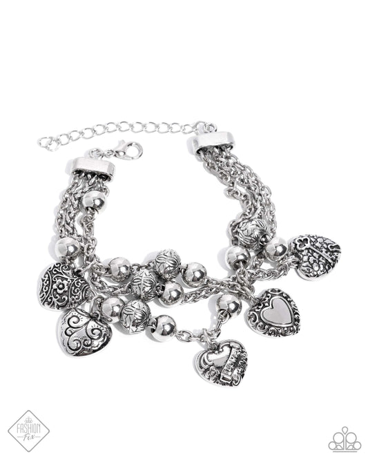 Spanning from silver fittings, a collection of classic silver chains spans around the wrist. Decorative floral and romantic-inspired filigree is embellished across a multitude of heart charms and silver beads while solid silver beads are also infused along the chains for a rustic, radiant display. Features an adjustable clasp closure.  Sold as one individual bracelet.