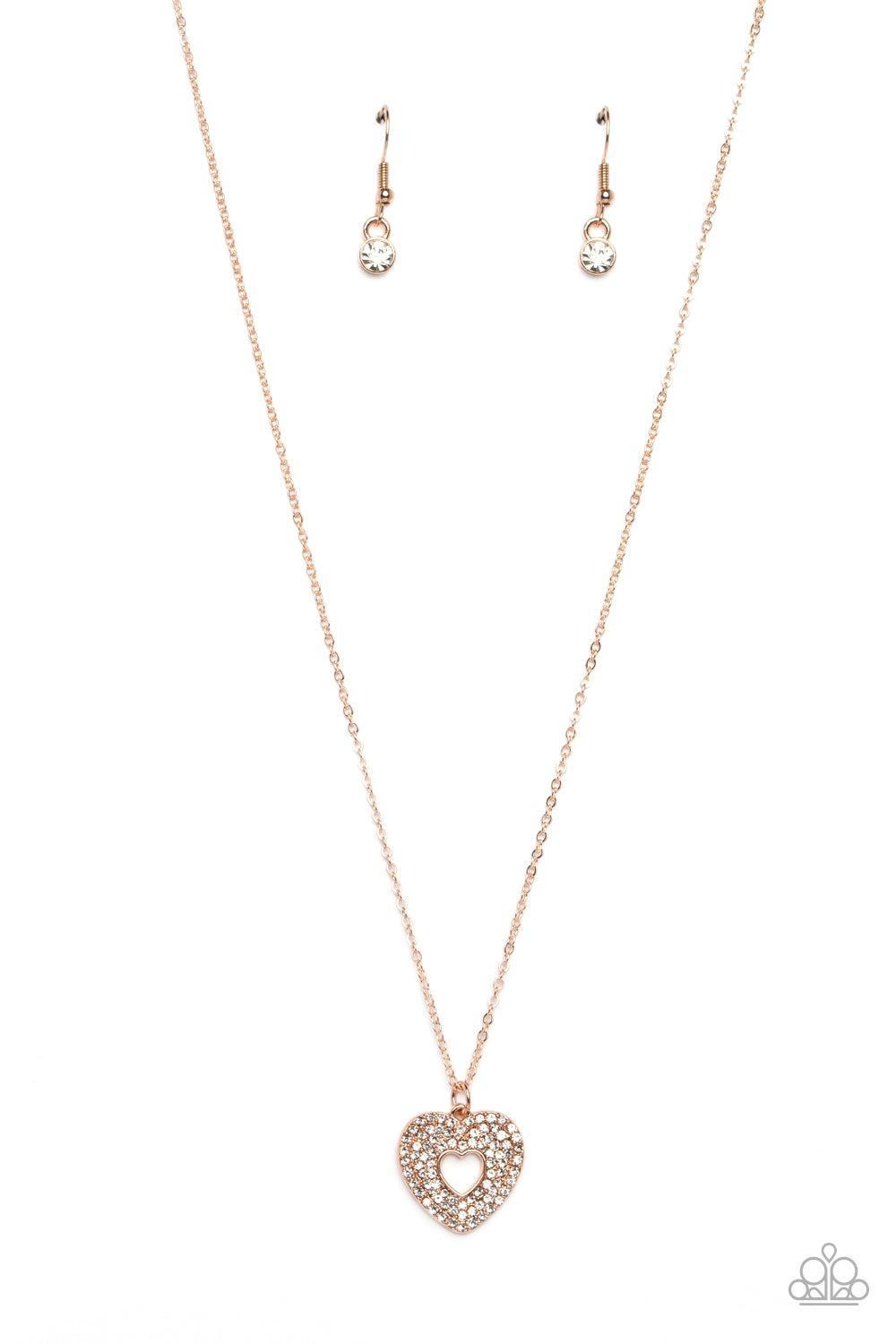 Bordered in stacked rows of dainty, glassy white rhinestones, a twinkly rose gold heart-shaped silhouette frame sparkles at the center of a dainty rose gold chain for a romantic finish. Features an adjustable clasp closure.  Sold as one individual necklace. Includes one pair of matching earrings.