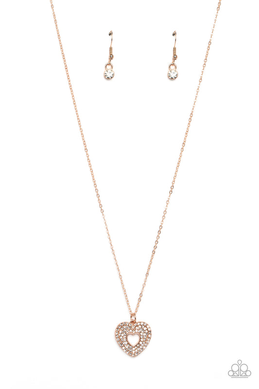 Bordered in stacked rows of dainty, glassy white rhinestones, a twinkly rose gold heart-shaped silhouette frame sparkles at the center of a dainty rose gold chain for a romantic finish. Features an adjustable clasp closure.  Sold as one individual necklace. Includes one pair of matching earrings.