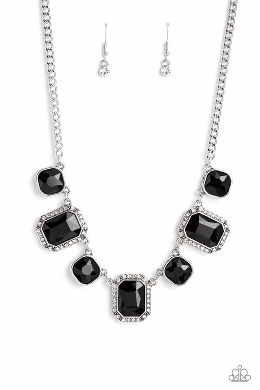 Dazzling gems, in both round and emerald-cuts, fall along the collar in an alternating pattern. Each gem is splashed in a dauntless, jet black hue amplifying its impact, while the emerald-cut gems showcase some glittery bling with a border of tiny white rhinestones. Features an adjustable clasp closure.  Sold as one individual necklace. Includes one pair of matching earrings.