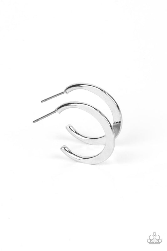 A deceptively simple hoop of silver smoothly curves around the ear. The flattened surface of the hoop catches the light, emitting radiant shimmer from the crescent-shaped curves. Earring attaches to a standard post fitting. Hoop measures approximately 3/4" in diameter.  Sold as one pair of hoop earrings.