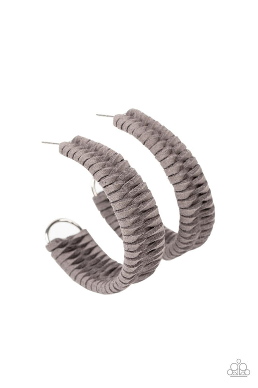 Gray suede cording crisscrosses around a layered silver frame that widens as it curves into a simple hoop, creating a textured handcrafted design. Hoop measures approximately 2" in diameter. Earring attaches to a standard post fitting.  Sold as one pair of hoop earrings.