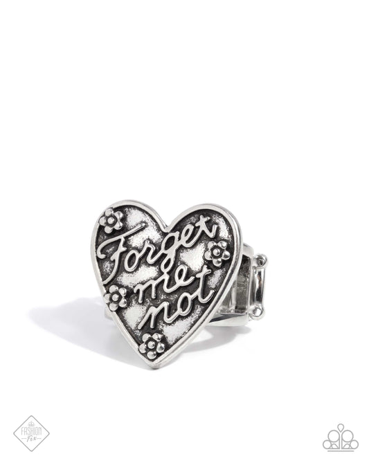 Featuring an antiqued motif, a silver heart with the phrase "Forget me not" in a cursive font and silver stud flowers glisten atop the center of airy silver bands for a romantically rustic centerpiece. Features a stretchy band for a flexible fit.  Sold as one individual ring.
