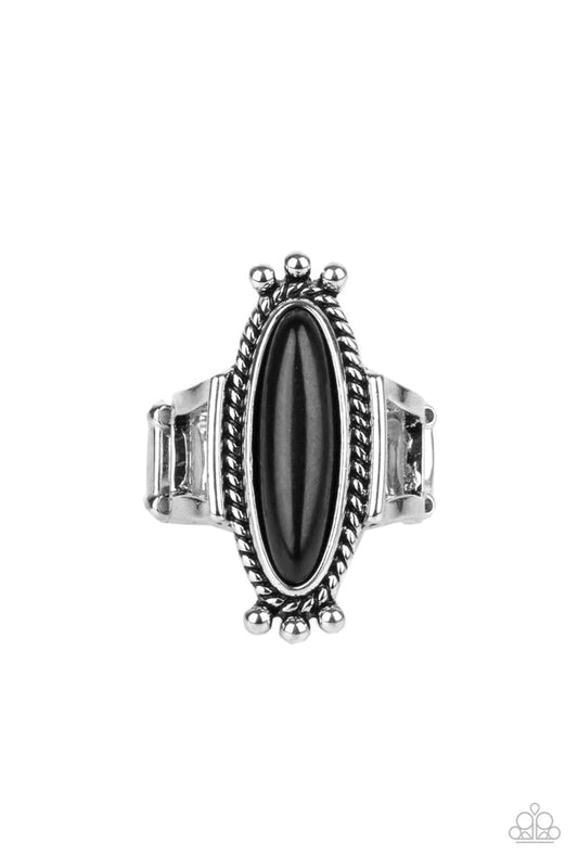 An oblong black stone is pressed into the center of a rustic silver frame radiating with studded and metallic ropelike textures, creating a seasonal centerpiece atop the finger. Features a stretchy band for a flexible fit.  Sold as one individual ring.