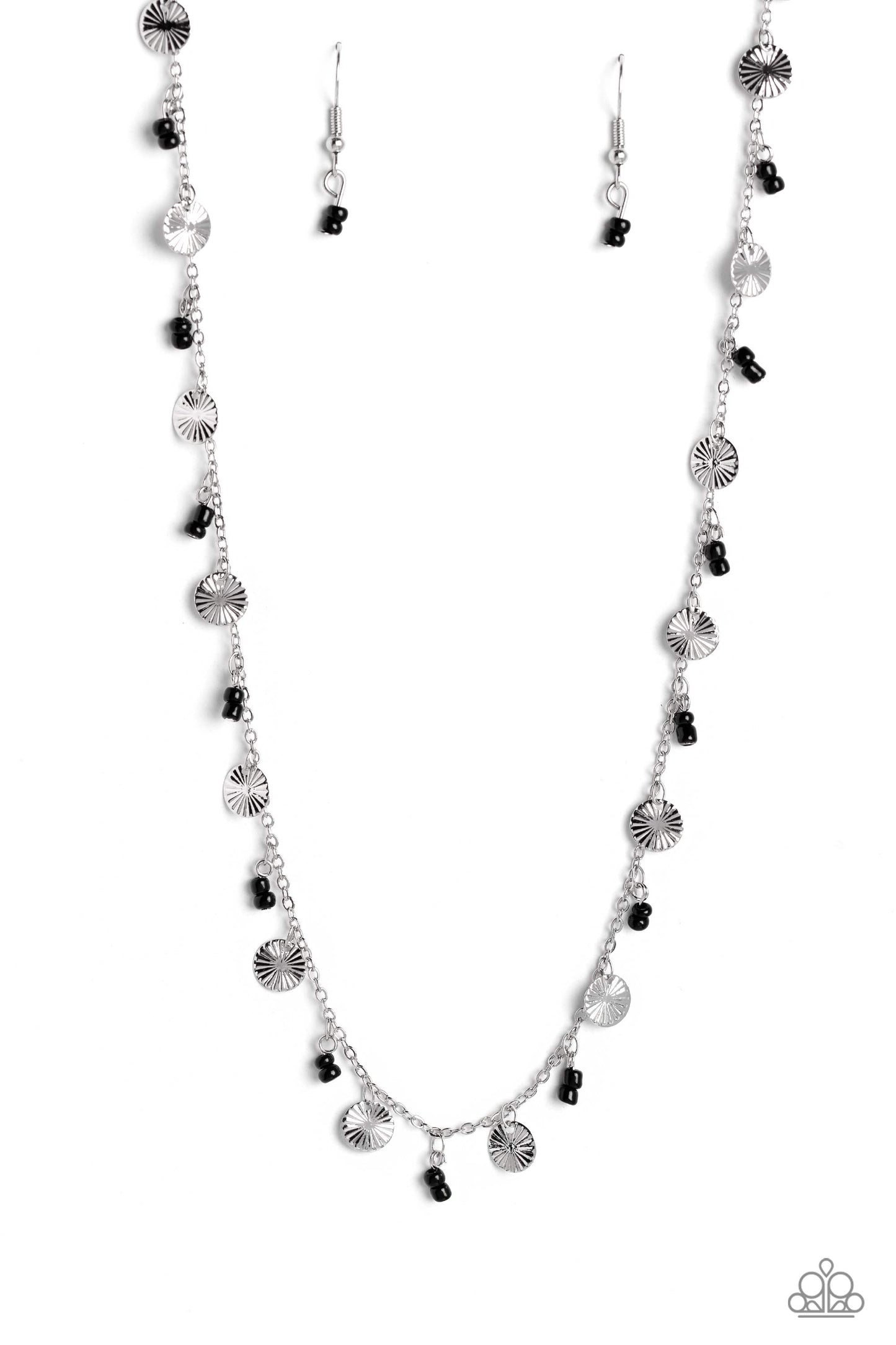 Infused along a dainty silver chain, duos of black seed beads alternate with warped, layered silver discs to make a colorful, sand-dollar-like statement down the neckline. Features an adjustable clasp closure.  Sold as one individual necklace. Includes one pair of matching earrings.