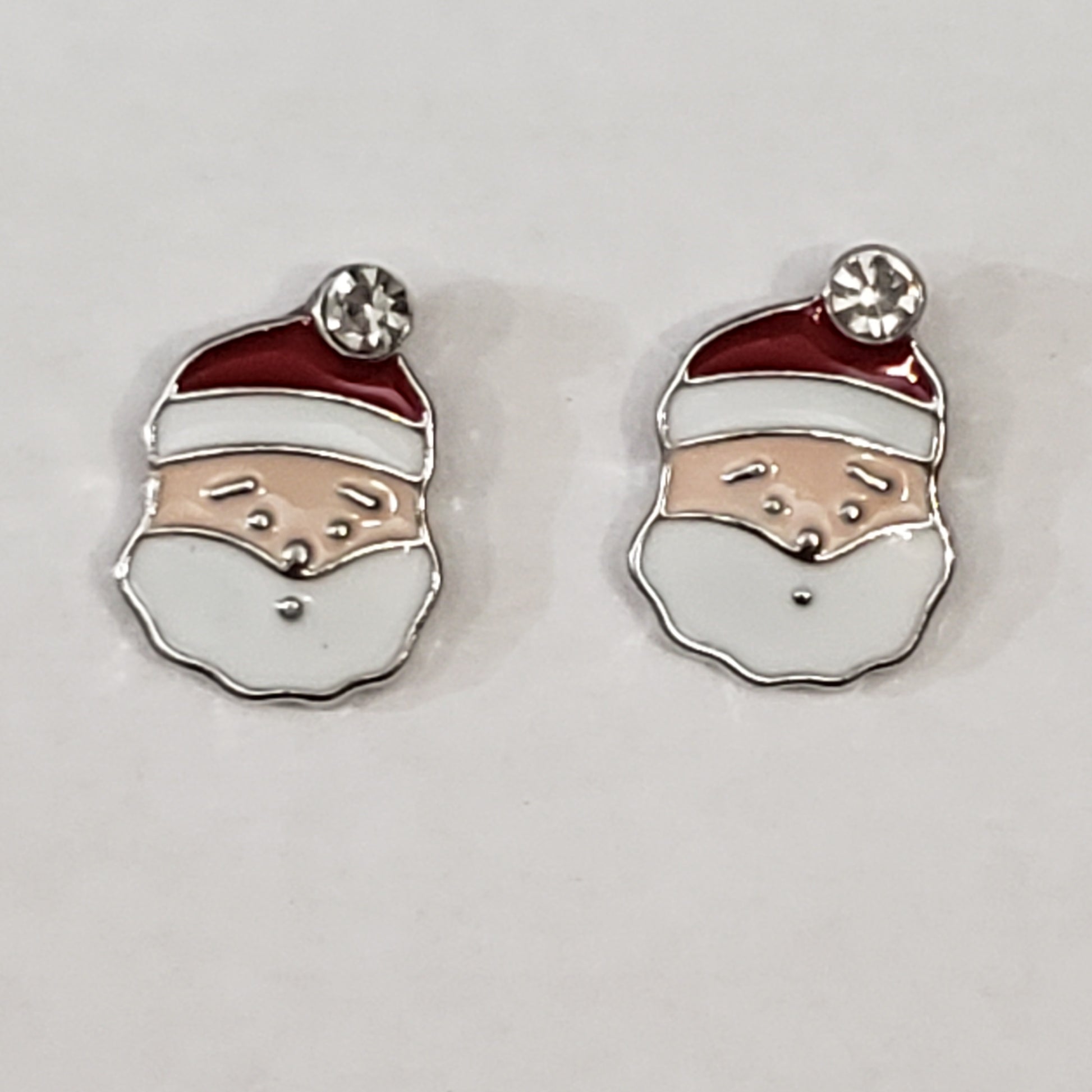 Santa clause earrings with white rhinestone on top of red hat