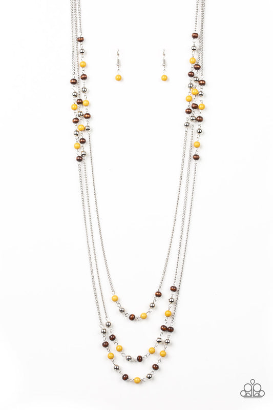 Dainty silver, yellow, and wooden beads trickle along three shimmery silver chains, creating colorful layers across the chest. Features an adjustable clasp closure.  Sold as one individual necklace. Includes one pair of matching earrings.