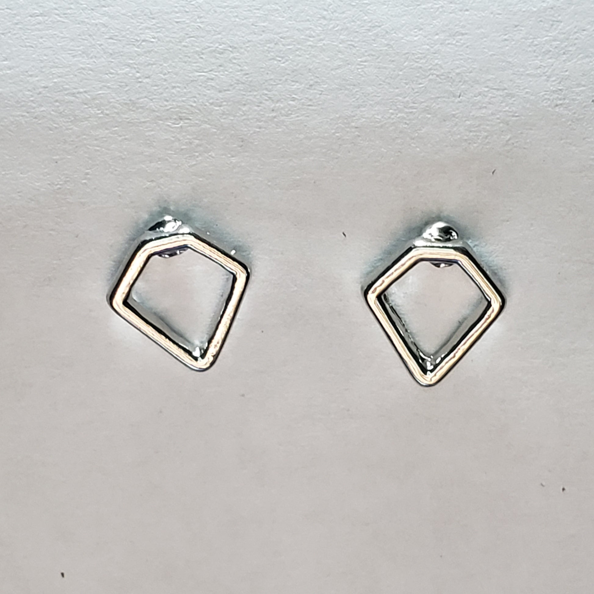 Kid's silver earring shaped like a diamond
