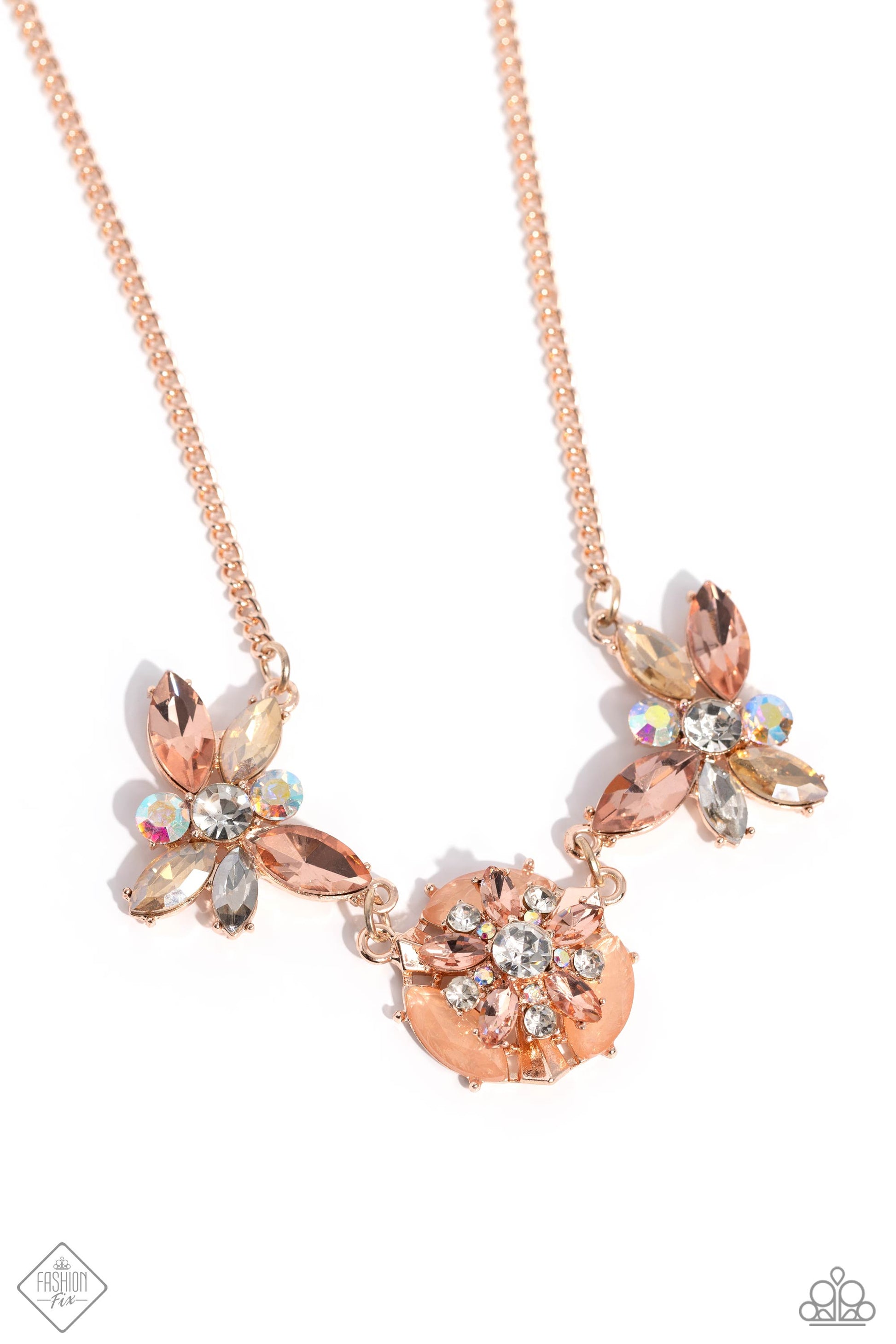 Modeled after a sand dollar motif, an explosion of marquise-cut peach gems and round white and iridescent rhinestones rest atop a shimmery rose gold disc accented with shimmery Tender Peach marquise-cut beads. Pronged in rose gold fittings, a refined display of peachy, champagne, white, and iridescent gems and rhinestones in round and marquise cuts fan out in a clustered display beside the rose gold center, creating a spectacular centerpiece. Features an adjustable clasp closure.