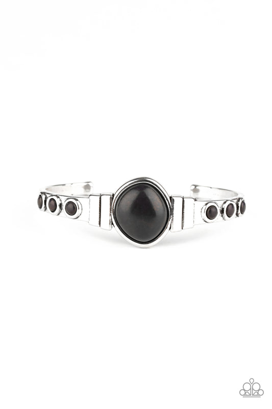 Dotted in dainty black stones, a dainty silver cuff attaches to an asymmetrical black stone centerpiece for an earthy flair.  Sold as one individual bracelet.