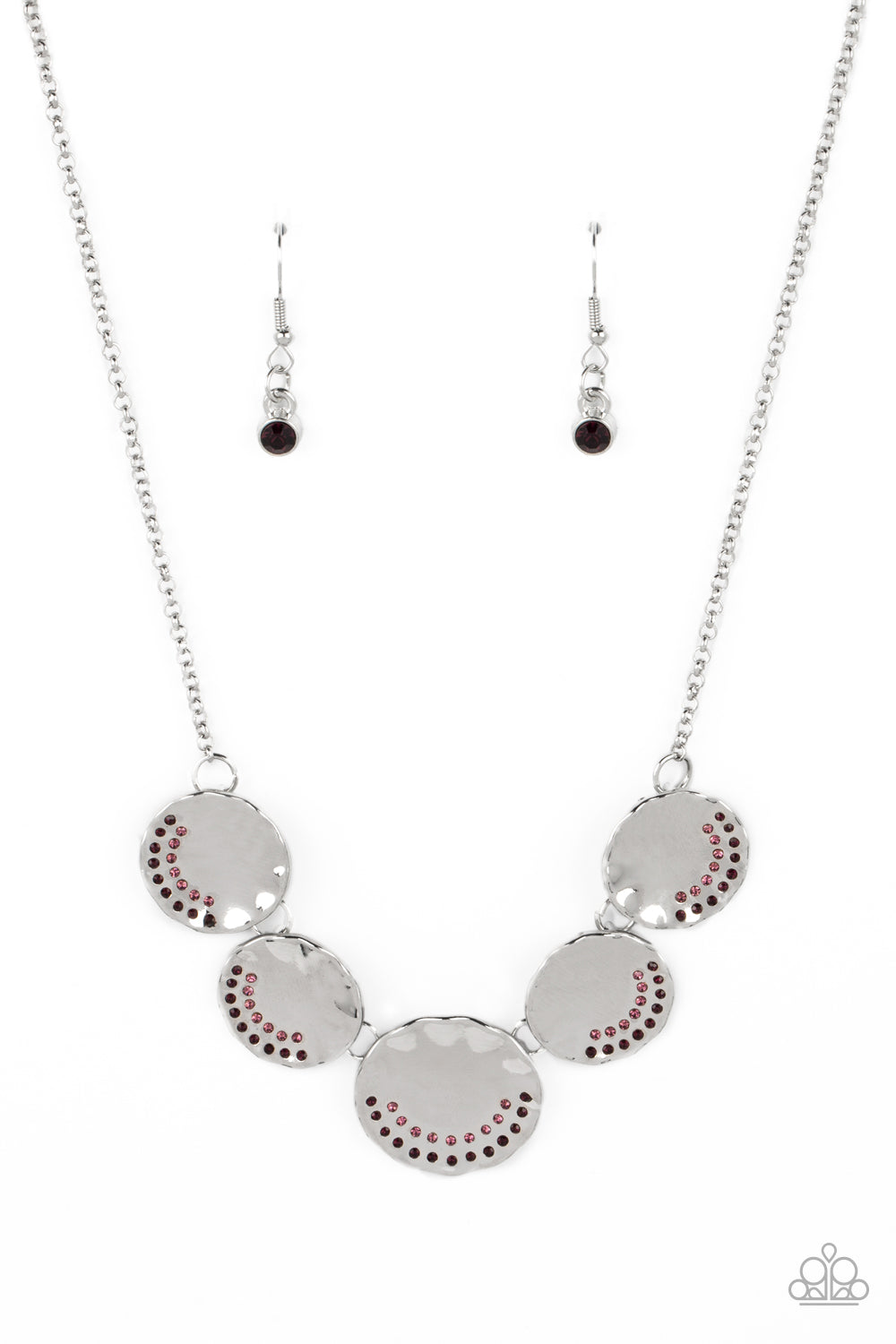 Embossed on the curve of a scalloped edge, a collection of dainty amethyst, and light amethyst rhinestones shimmer on a row of reflective, silver discs. The raised edges of the disc, due to its concave center, scatter light and glitz in every direction. Features an adjustable clasp closure.  Sold as one individual necklace. Includes one pair of matching earrings.