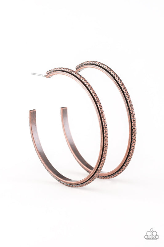 The inside and outside of a folded copper hoop is stamped in tribal inspired textures for a trendy look. Earring attaches to a standard post fitting. Hoop measure approximately 2" in diameter.  Sold as one pair of hoop earrings.