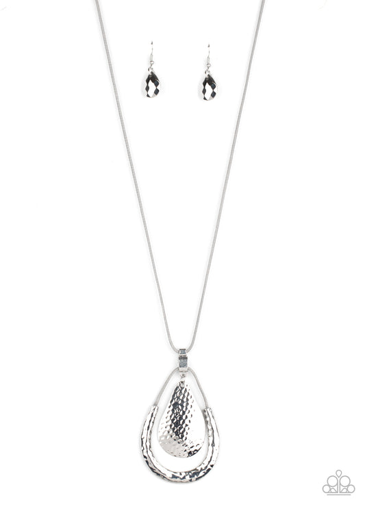 Attached to a shiny silver fitting, a hammered silver teardrop swings from the top of a shiny gray cord pendant featuring a hammered silver accent. The stacked pendants swing from the bottom of a lengthened piece of gray cord for a colorfully trendy look. Features an adjustable clasp closure.  Sold as one individual necklace. Includes one pair of matching earrings.