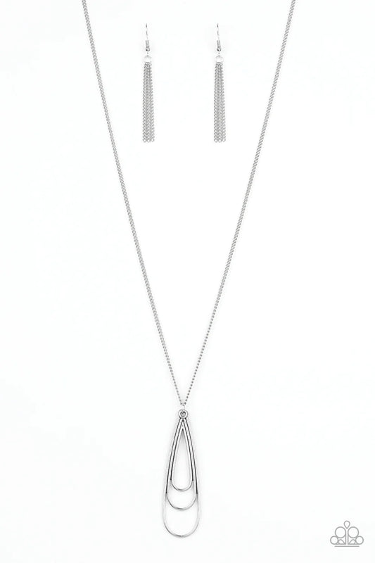 Gradually increasing in size, glistening silver teardrops coalesce into a rippling frame for an edgy look. The airy pendant swings from the bottom of a lengthened silver chain for an edgy look. Features an adjustable clasp closure.  Sold as one individual necklace. Includes one pair of silver fringe earrings.