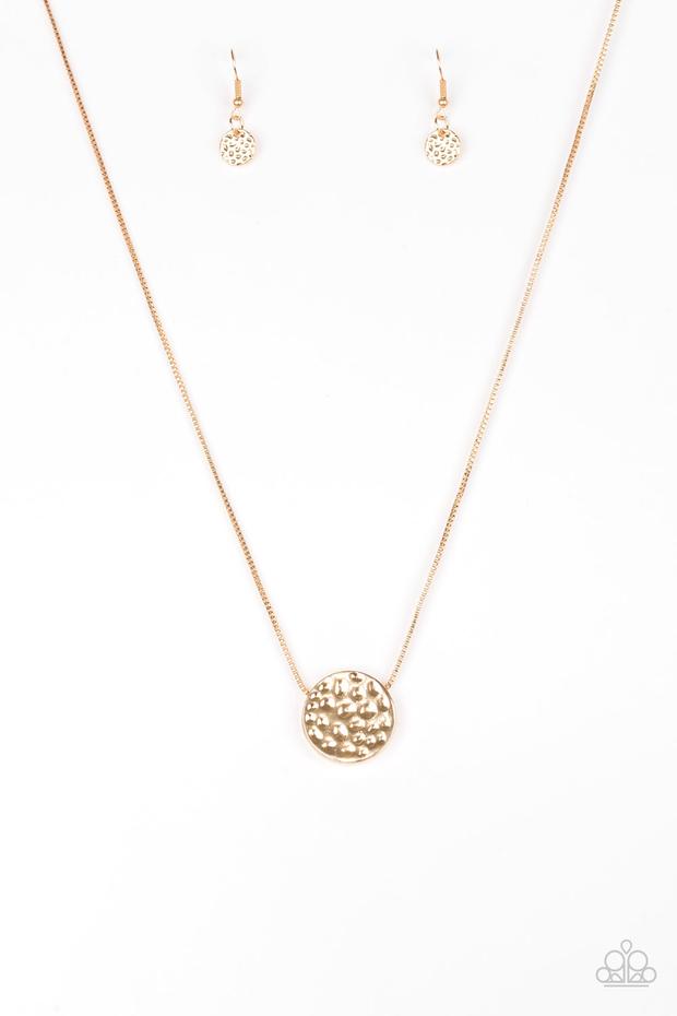 Delicately hammered in shimmery detail, a glistening gold pendant slides along a dainty gold box-chain below the collar for a bold look. Features an adjustable clasp closure.  Sold as one individual necklace. Includes one pair of matching earrings.
