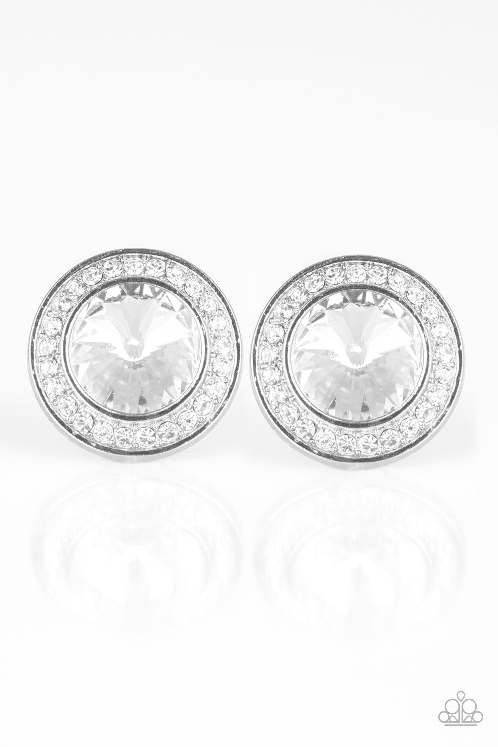 A faceted white gem is pressed into the center of a shimmery silver frame encrusted in a ring of glassy white rhinestones for a timeless fashion. Earring attaches to a standard post fitting.  Sold as one pair of post earrings.