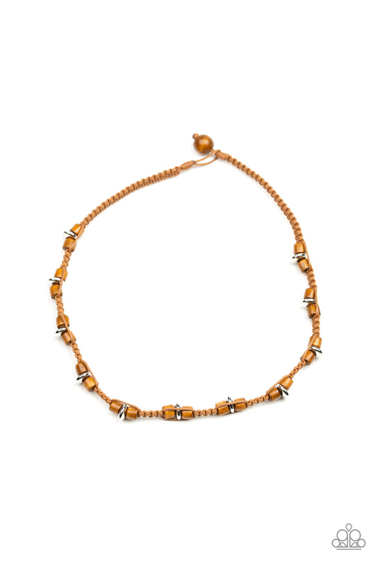 Braided cording knots around earthy wooden and shiny silver beads below the collar for an urban look. Features a button loop closure.  Sold as one individual necklace.